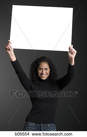 Woman standing with blank sign View Large Photo Image Picture - Woman standing with blank sign. Fotosearch