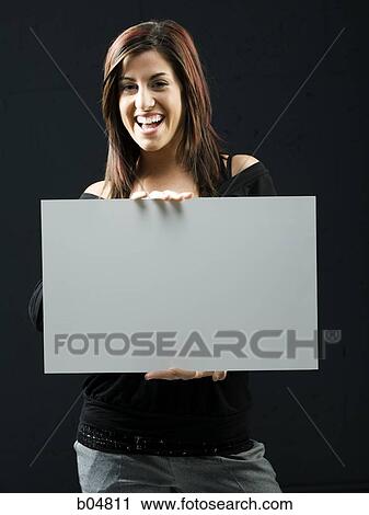 Woman standing with blank sign View Large Photo Image Stock Image - Woman standing with blank sign. Fotosearch