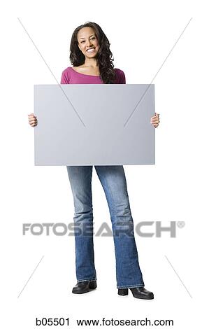 Woman standing with blank sign View Large Photo Image Stock Image - Woman standing with blank sign. Fotosearch