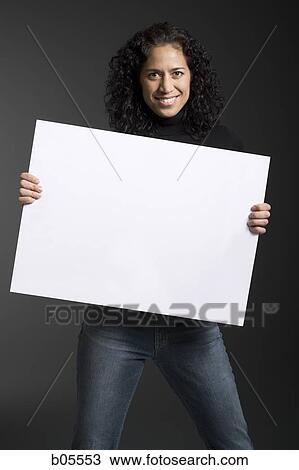 Woman standing with blank sign View Large Photo Image Stock Image - Woman standing with blank sign. Fotosearch