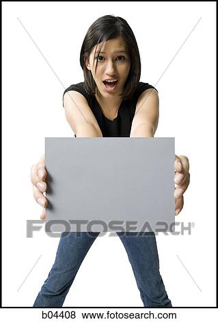 Stock Photo - Woman standing with blank sign. Fotosearch
