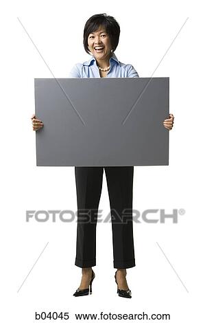 Woman standing with blank sign View Large Photo Image Stock Photography - Woman standing with blank sign. Fotosearch