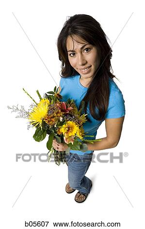 Woman standing with bouquet of flowers View Large Photo Image Stock Photo - Woman standing with bouquet of flowers. Fotosearch