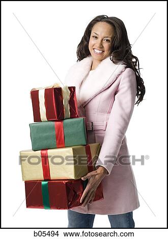 Woman standing with Christmas gifts View Large Photo Image Picture - Woman standing with Christmas gifts. Fotosearch