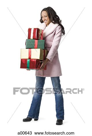 Woman standing with Christmas gifts View Large Photo Image Stock Image - Woman standing with Christmas gifts. Fotosearch