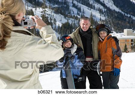 Woman taking a picture of her family outside View Large Photo Image Stock Image - Woman taking a picture of her family outside. Fotosearch