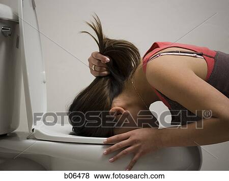 Woman throwing up into the toilet View Large Photo Image Stock Photo - Woman throwing up into the toilet. Fotosearch