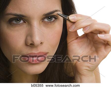 Woman tweezing eyebrows View Large Photo Image Stock Photography - Woman tweezing eyebrows. Fotosearch