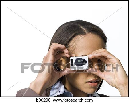 Woman using a camera View Large Photo Image Stock Image - Woman using a camera. Fotosearch