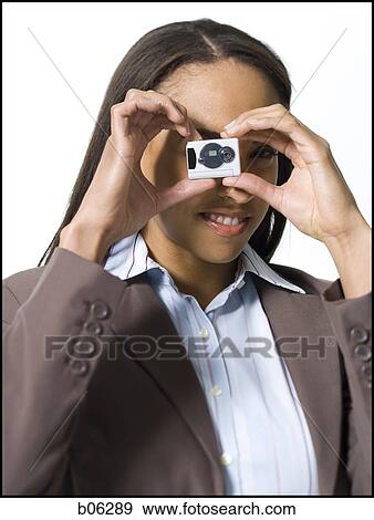 Stock Photo - Woman using a camera. Fotosearch