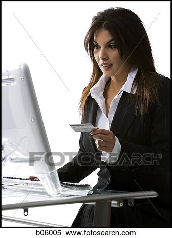 Woman using her credit card on her computer View Large Photo Image Stock Photography - Woman using her credit card on her computer. Fotosearch