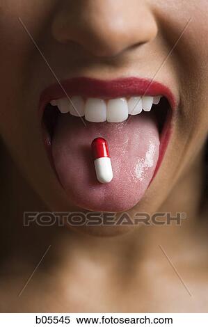 Woman wearing red lipstick with a pill on tongue View Large Photo Image Stock Photography - Woman wearing red lipstick with a pill on tongue. Fotosearch