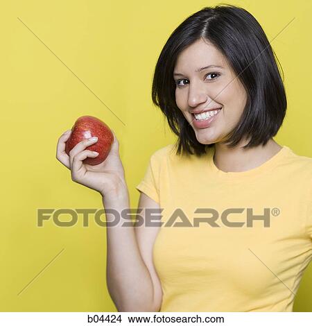 Woman with a red apple View Large Photo Image Picture - Woman with a red apple. Fotosearch