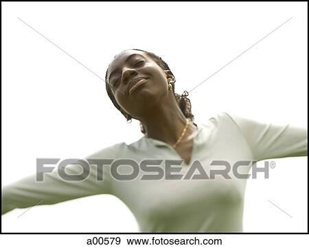 Woman with arms up and eyes closed View Large Photo Image Stock Photo - Woman with arms up and eyes closed. Fotosearch