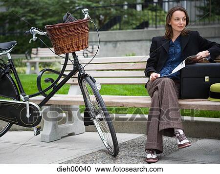 Stock Image - Woman with bicycle and briefcase. Fotosearch