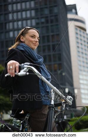 Stock Image - Woman with bicycle. Fotosearch