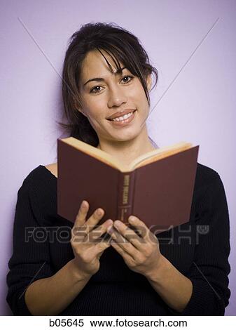 Woman with book smiling View Large Photo Image Stock Photography - Woman with book smiling. Fotosearch