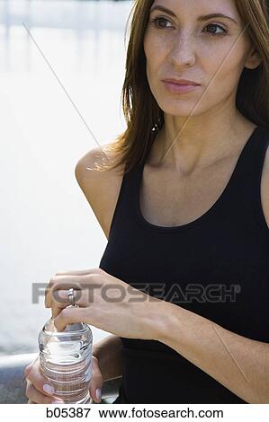 Woman with bottled water View Large Photo Image Stock Photo - Woman with bottled water. Fotosearch