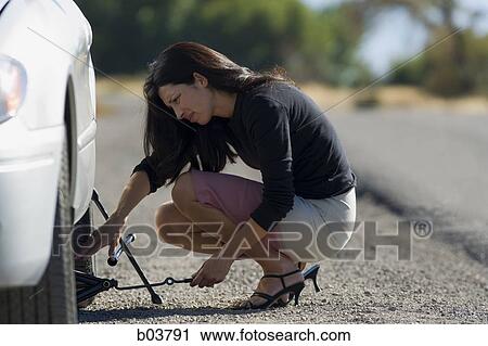 Woman with car jack View Large Photo Image Stock Image - Woman with car jack. Fotosearch
