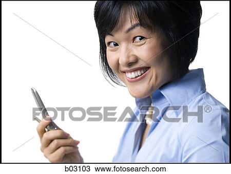 Stock Image - Woman with cell phone smiling. Fotosearch