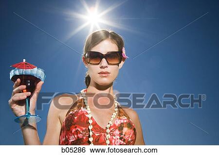 Woman with cocktail and sunglasses outdoors View Large Photo Image Stock Photograph - Woman with cocktail and sunglasses outdoors. Fotosearch