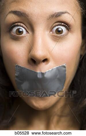 Woman with duct tape over mouth View Large Photo Image Stock Photo - Woman with duct tape over mouth. Fotosearch