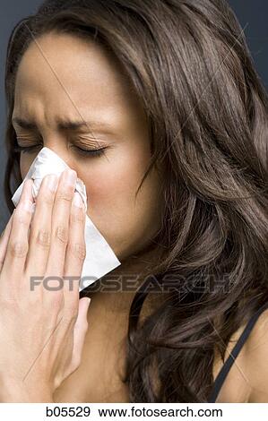 Woman with eyes closed blowing nose View Large Photo Image Stock Photo - Woman with eyes closed blowing nose. Fotosearch