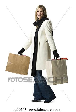Stock Photo - Woman with gift bags. Fotosearch