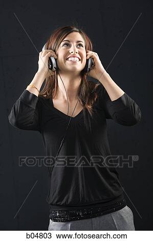 Woman with headphones smiling View Large Photo Image Stock Image - Woman with headphones smiling. Fotosearch