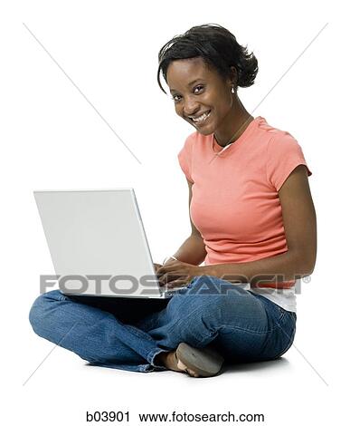 Woman with laptop sitting cross legged View Large Photo Image Stock Image - Woman with laptop sitting cross legged. Fotosearch