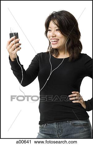 Woman with mp3 player smiling View Large Photo Image Stock Image - Woman with mp3 player smiling. Fotosearch
