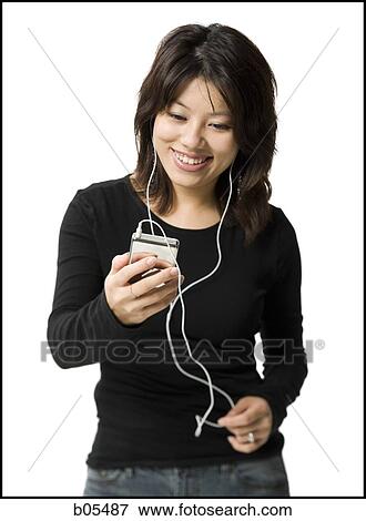 Woman with mp3 player smiling View Large Photo Image Stock Photo - Woman with mp3 player smiling. Fotosearch