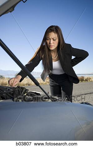 Woman with open car engine View Large Photo Image Stock Photo - Woman with open car engine. Fotosearch