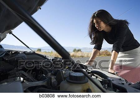 Woman with open car engine View Large Photo Image Stock Photo - Woman with open car engine. Fotosearch
