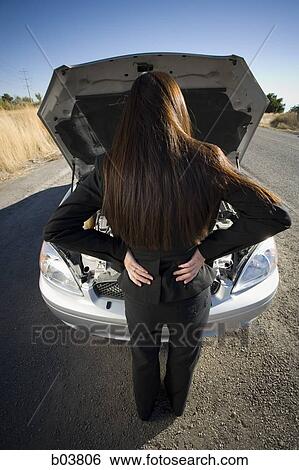 Stock Photograph - Woman with open car engine. Fotosearch