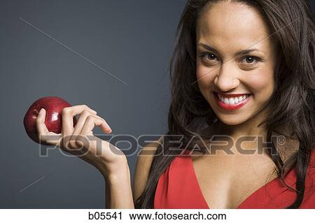 Woman with red lipstick and red apple smiling View Large Photo Image Stock Image - Woman with red lipstick and red apple smiling. Fotosearch