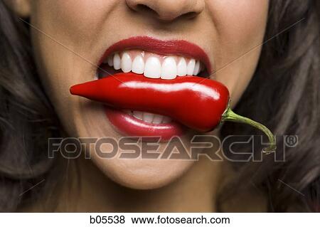 Woman with red lipstick eating red pepper View Large Photo Image Stock Photo - Woman with red lipstick eating red pepper. Fotosearch
