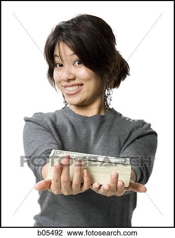 Woman with stack of US currency smiling View Large Photo Image Stock Image - Woman with stack of US currency smiling. Fotosearch