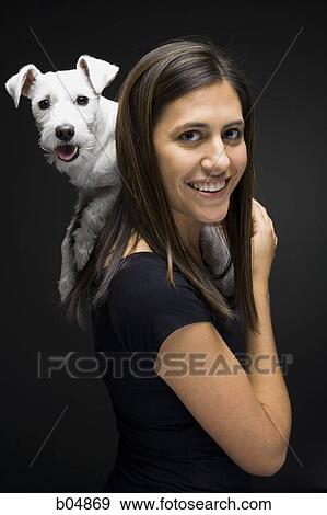 Stock Photo - Woman with white dog on shoulder. Fotosearch