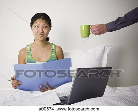 Woman working from bed View Large Photo Image Picture - Woman working from bed. Fotosearch