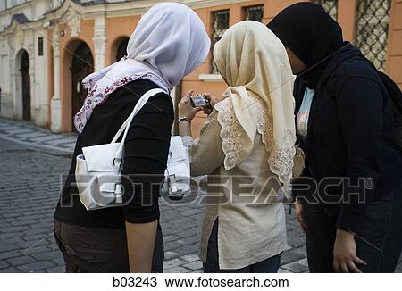 Women in scarves looking down at camera View Large Photo Image Stock Image - Women in scarves looking down at camera. Fotosearch