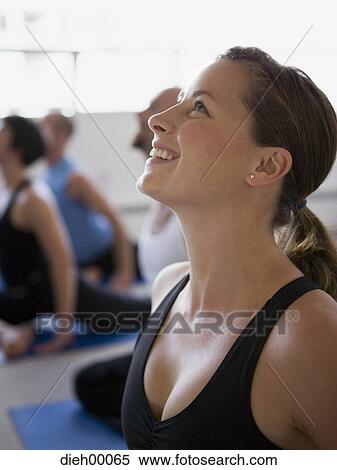 Stock Photography - Yoga group with woman looking up. Fotosearch