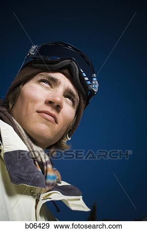 Stock Photo - Young adult man outside in the snow. Fotosearch