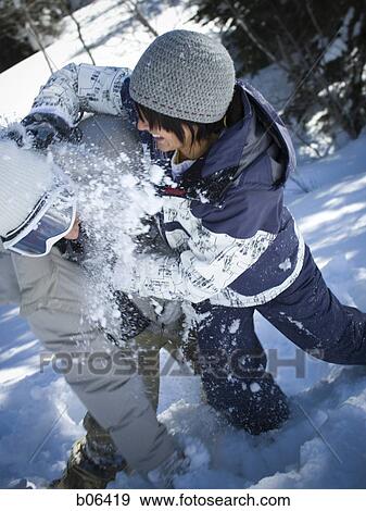 Young adults play fighting in the snow View Large Photo Image Stock Photo - Young adults play fighting in the snow. Fotosearch
