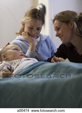 Young boy in hospital bed with family View Large Photo Image Picture - Young boy in hospital bed with family. Fotosearch