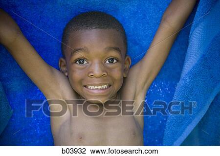 Young boy with blue towel smiling View Large Photo Image Stock Image - Young boy with blue towel smiling. Fotosearch