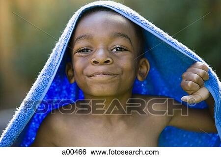 Stock Photograph - Young boy with towel on his head. Fotosearch
