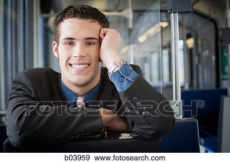 Young businessman on city bus or subway View Large Photo Image Stock Photo - Young businessman on city bus or subway. Fotosearch