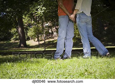 Young couple hiding View Large Photo Image Stock Photograph - Young couple hiding. Fotosearch