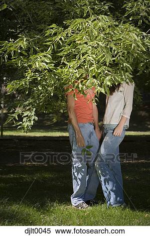 Stock Photography - Young couple hiding. Fotosearch
